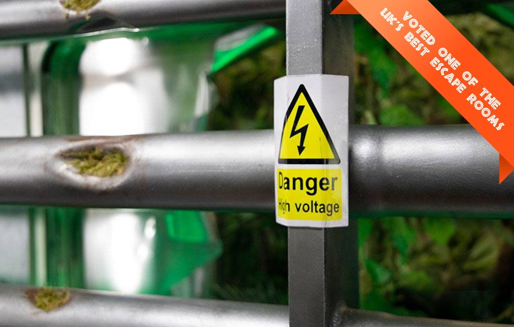 Steel bars and a high-voltage warning sign inside Dino Deadlock